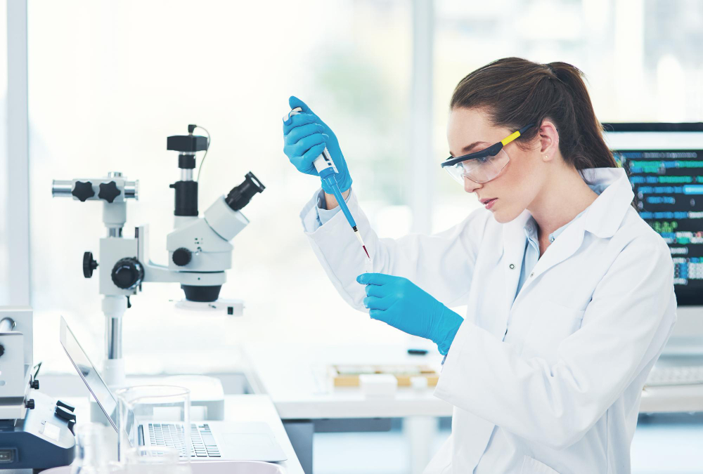 shes concentration mode cropped shot focused young female scientist wearing protective glasses while pouring test sample into vile inside laboratory